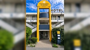 A hotel entrance with a prominent sign reading 'Premiere Classe Hotels' and a reception desk. - Premiere Classe Compiègne - Jaux (Jaux)