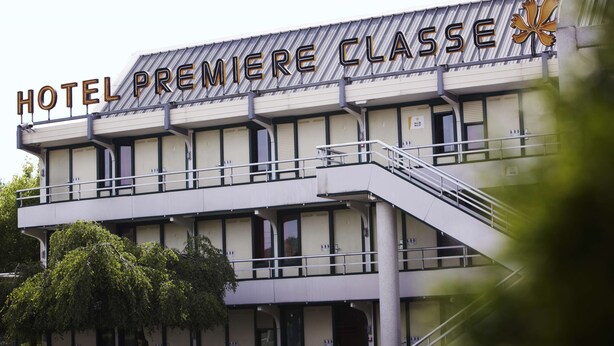 A hotel named "HOTEL PREMIERE CLASSE" with a modern architectural design, featuring a prominent balcony and a staircase leading to the entrance. - Premiere Classe Compiègne - Jaux (Jaux)