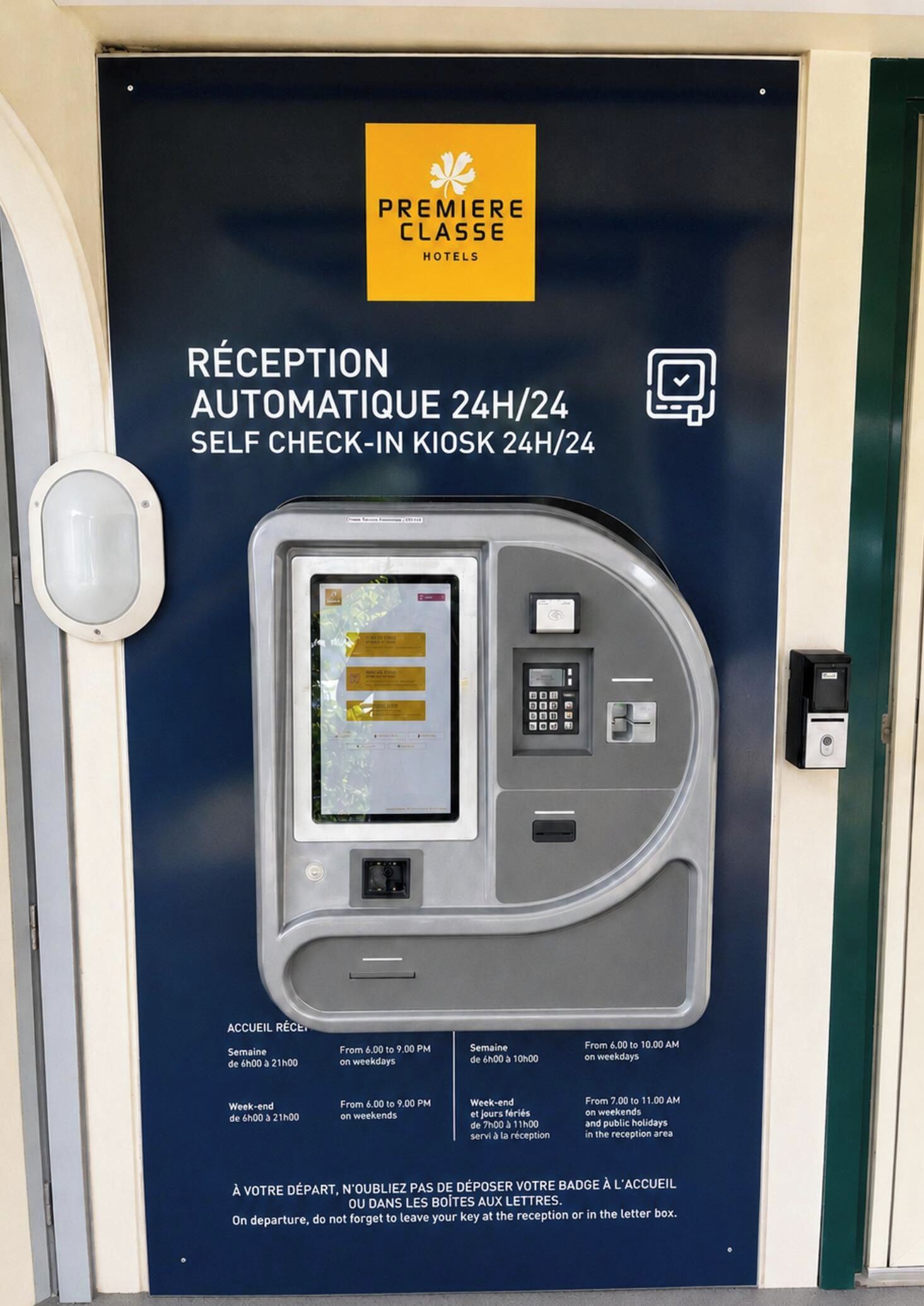 A self-check-in kiosk at a hotel reception with 24/7 availability.