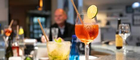 A bar area with various drinks and bottles.
