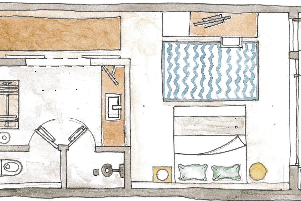 A floor plan of a hotel with a central lobby, multiple rooms, a dining area, and a bathroom.