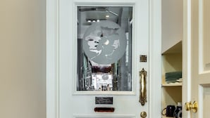 A white door with a glass panel and a brass handle. - The Golden Arm (Chicago)