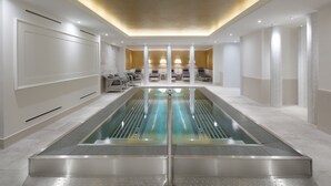 A modern spa area with a central pool, seating area, and ambient lighting. - Clarion Grandhotel Zlaty Lev (Liberec)