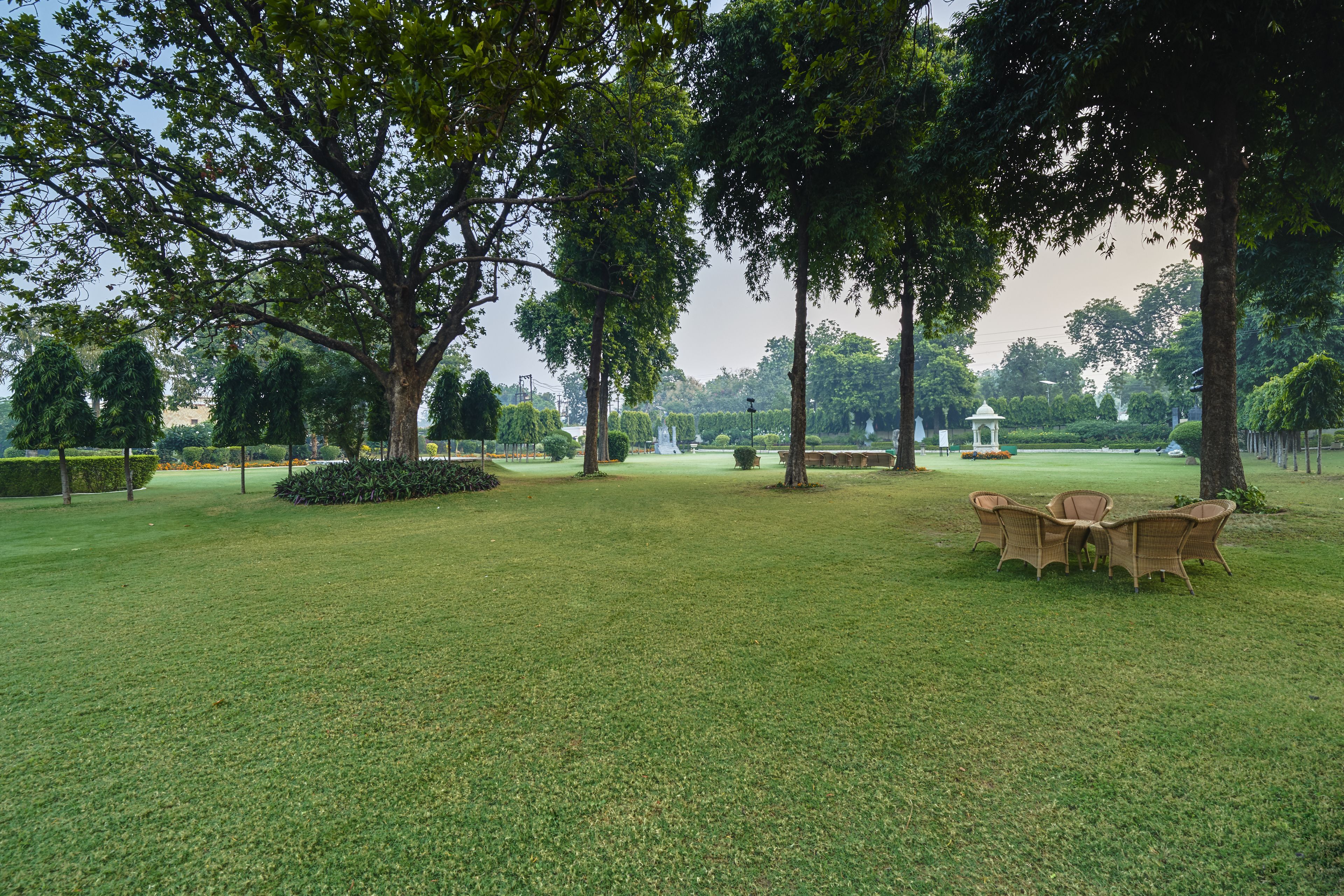 A park with a grassy area, trees, and a gazebo.