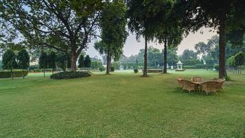 A park with a grassy area, trees, and a gazebo.