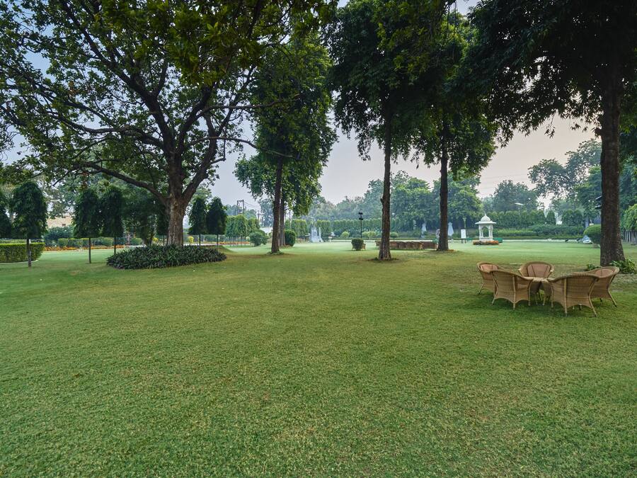 A park with a grassy area, trees, and a gazebo.