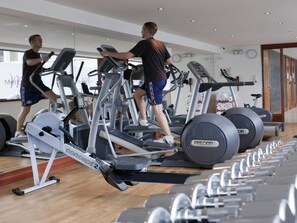 A gym with treadmills, stationary bikes, and rowing machines. - Mercure Bristol Holland House (Bristol)