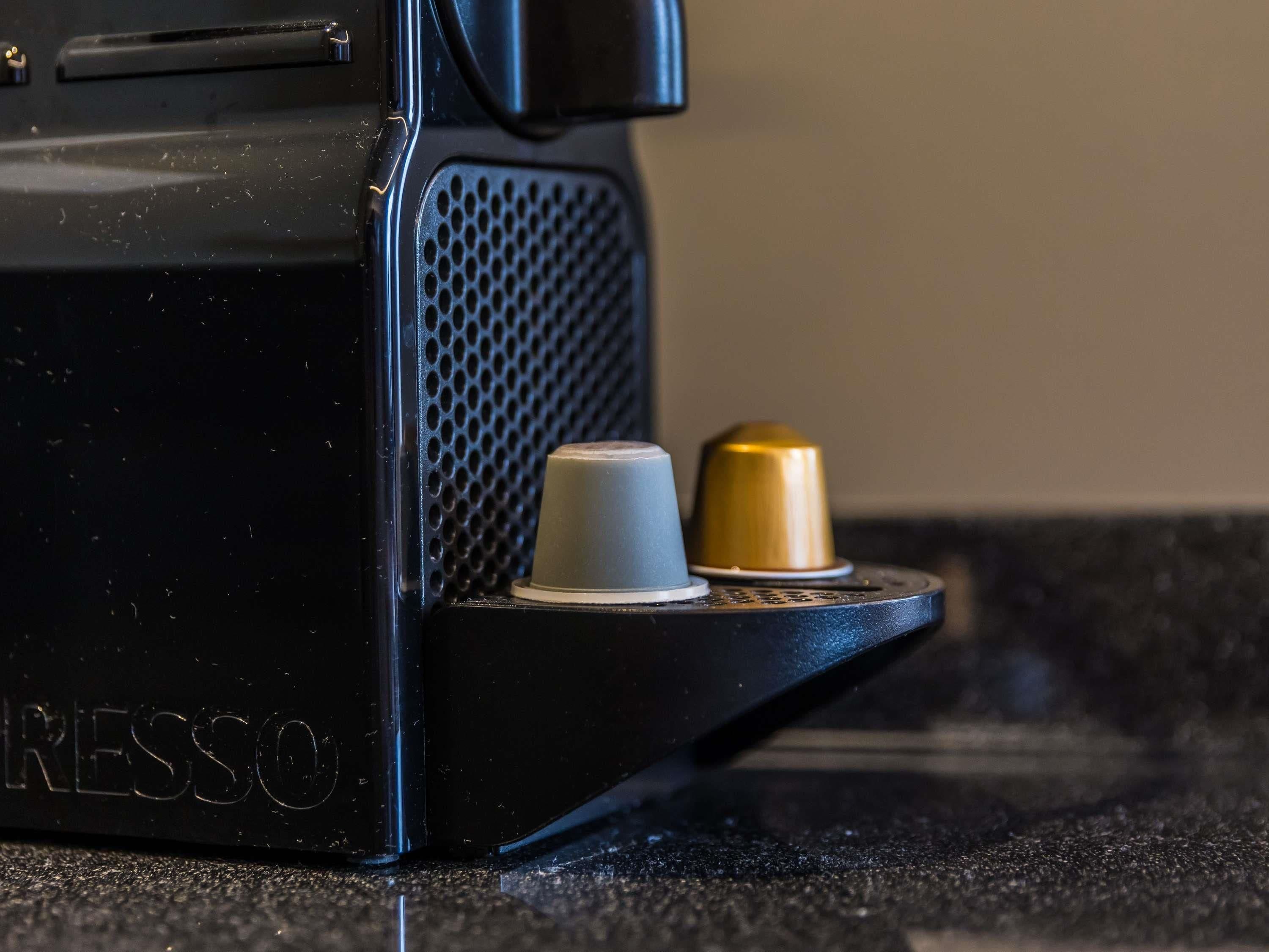 A coffee machine with a drip tray and two coffee cups.