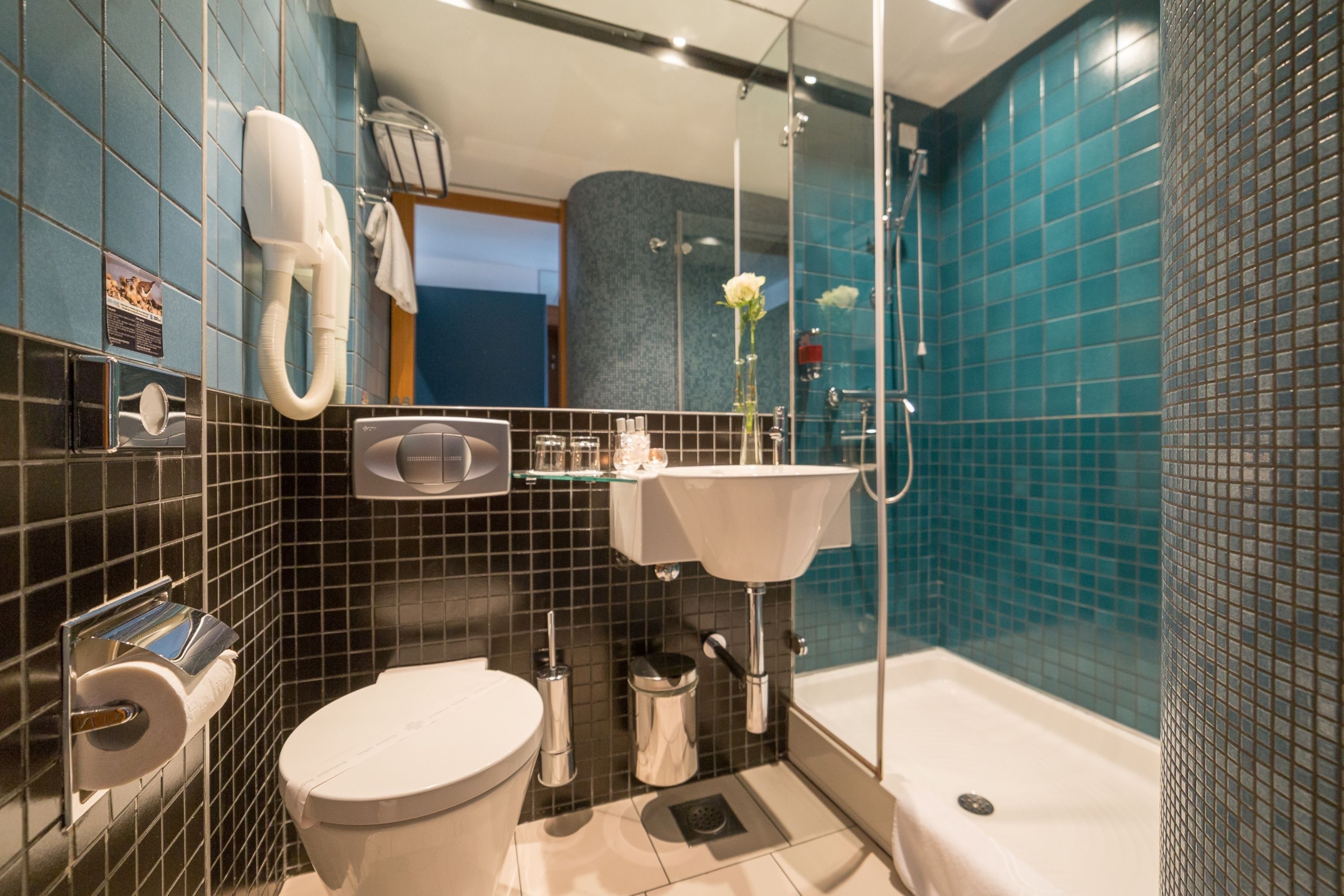 A modern bathroom with a toilet, sink, and bathtub.