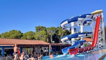 A water park with multiple slides and a pool area.