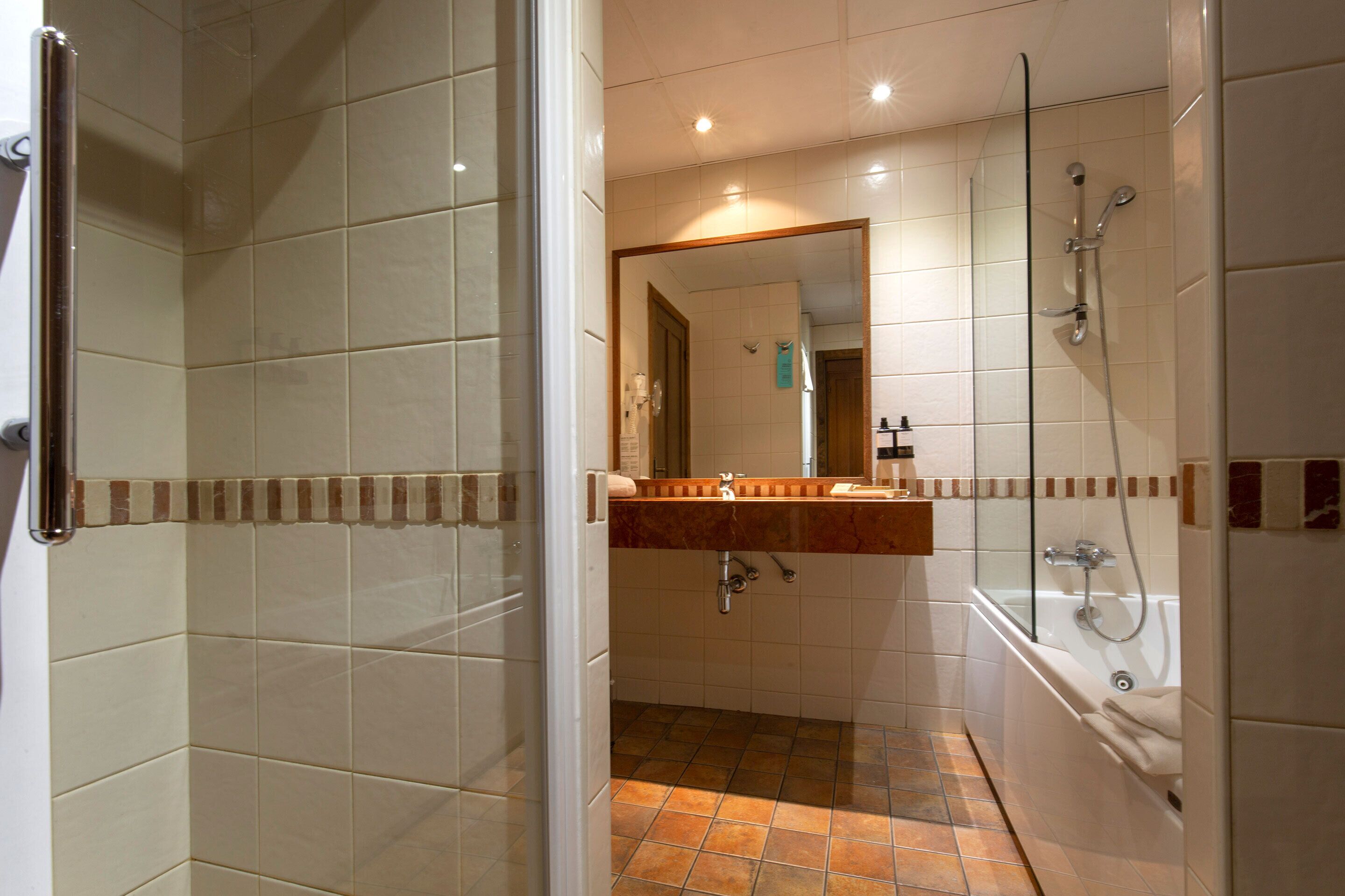 superior quadruple room | bathroom | shower, hair dryer, towels, soap