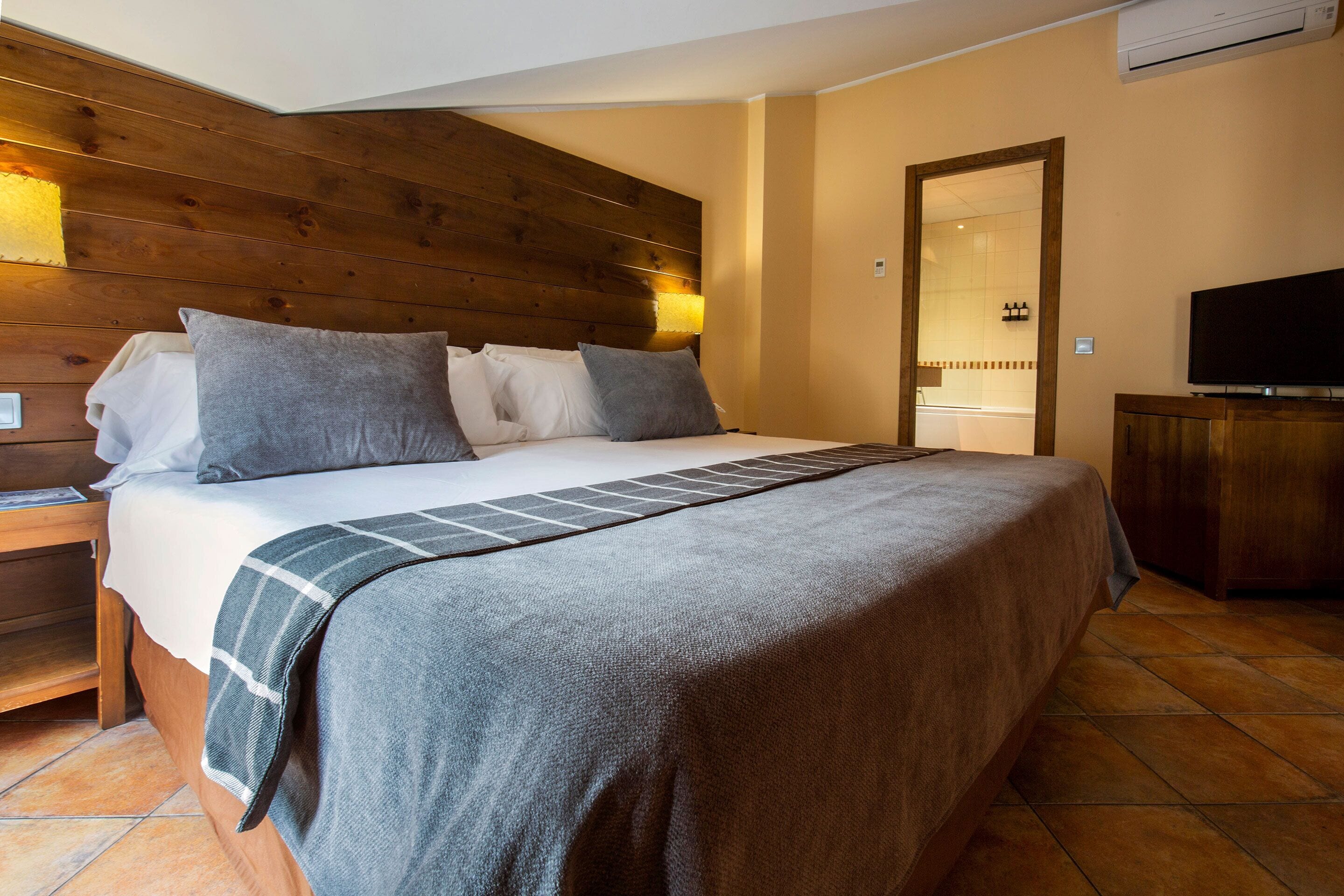 Superior Quadruple Room | Minibar, in-room safe, desk, laptop workspace