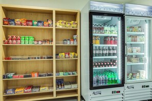 A vending machine stocked with various snacks and beverages, including chips, nuts, and sodas. - Holiday Inn Express & Suites Fleming Island by IHG (Fleming Island)