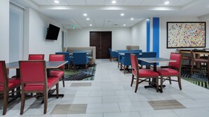 A hotel room with a flat-screen TV mounted on the wall, a large window, and a door leading to the outside. - Holiday Inn Express & Suites Fleming Island by IHG (Fleming Island)