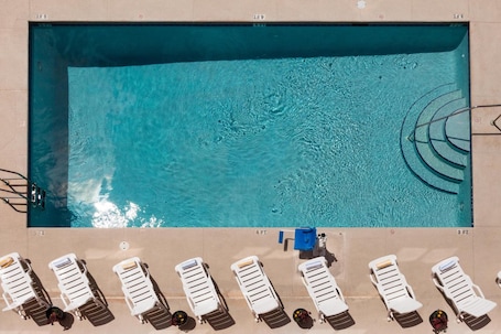 Outdoor pool, open 9:00 AM to 10:00 PM, sun loungers