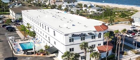 A hotel named Amelia with a rooftop pool, located near a beach.