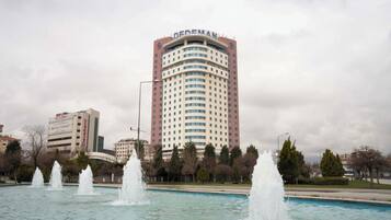 A hotel with a curved facade, multiple floors, and a prominent sign at the top.