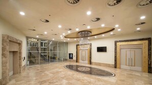 A spacious lobby with a marble floor, a central chandelier, and a staircase leading to upper floors. - Dedeman Konya Hotel And Convention Center (Konya)
