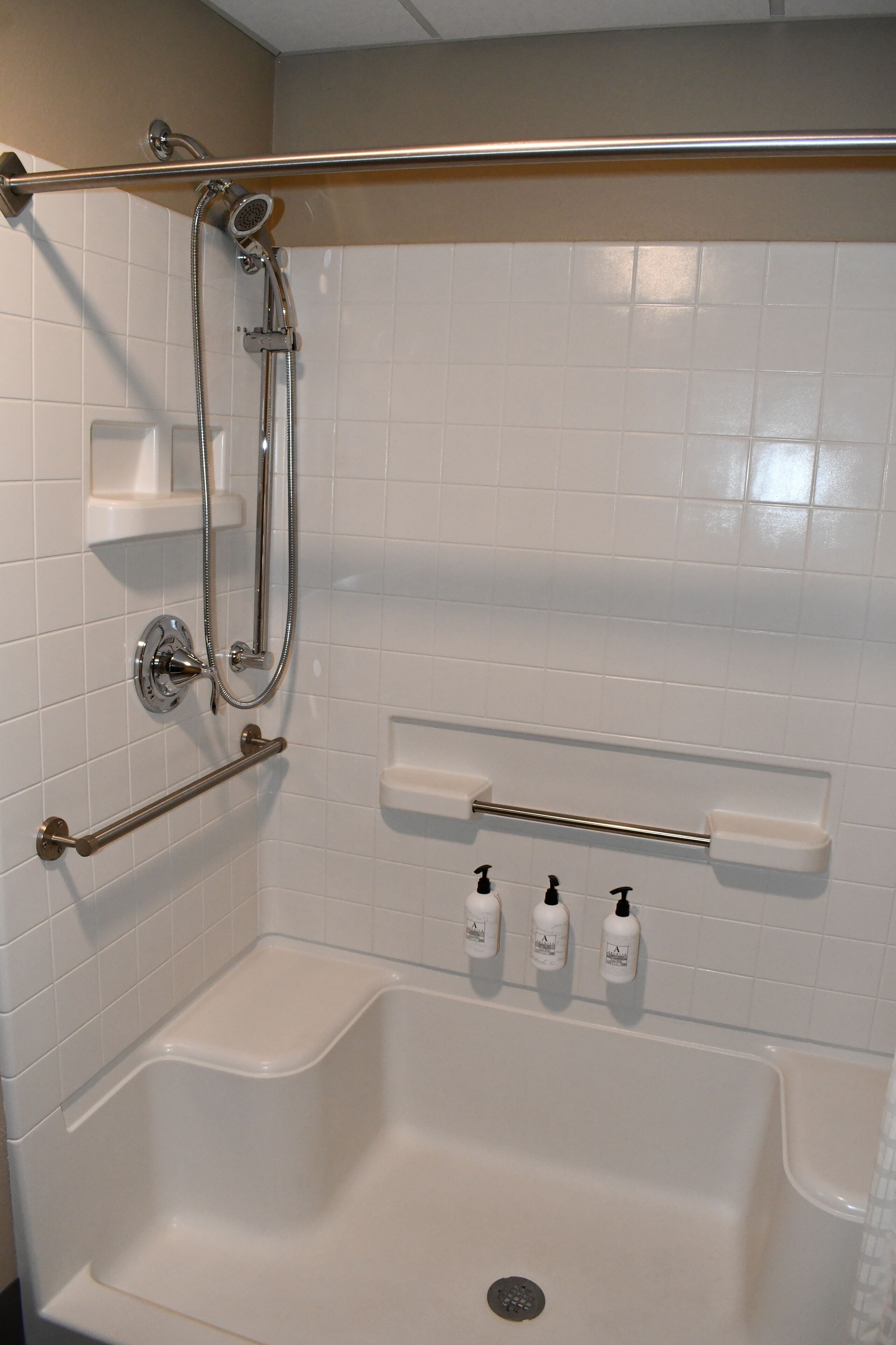 A bathroom with a shower, a bathtub, and a toilet.