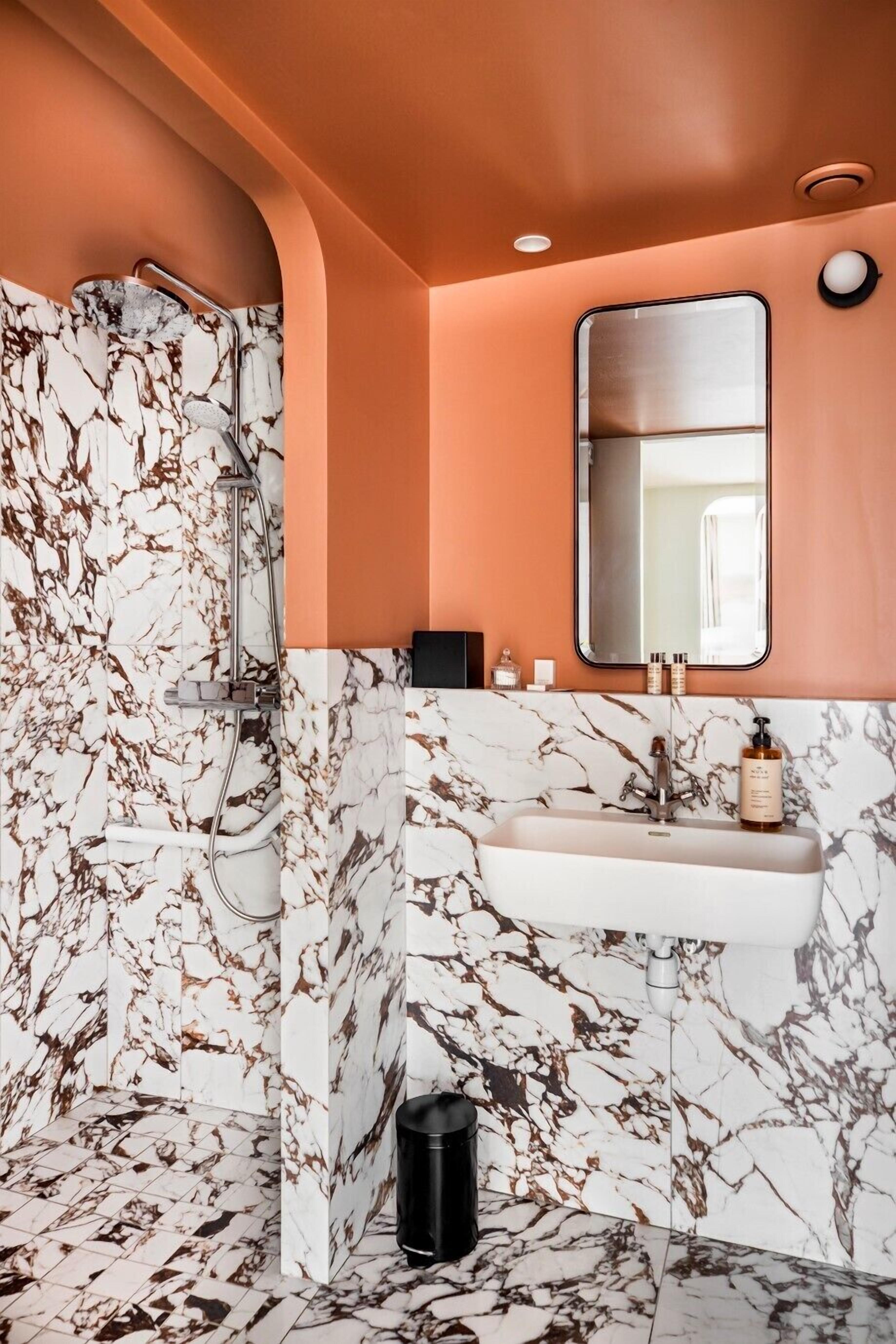 deluxe room | bathroom | shower, rainfall showerhead, designer toiletries, hair dryer