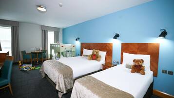 Cozy retreat with two single beds, a desk, and a table, perfect for families.