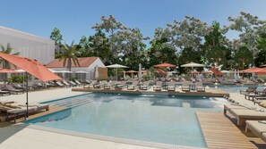 Relax by the pool surrounded by lush greenery and comfortable lounge chairs.