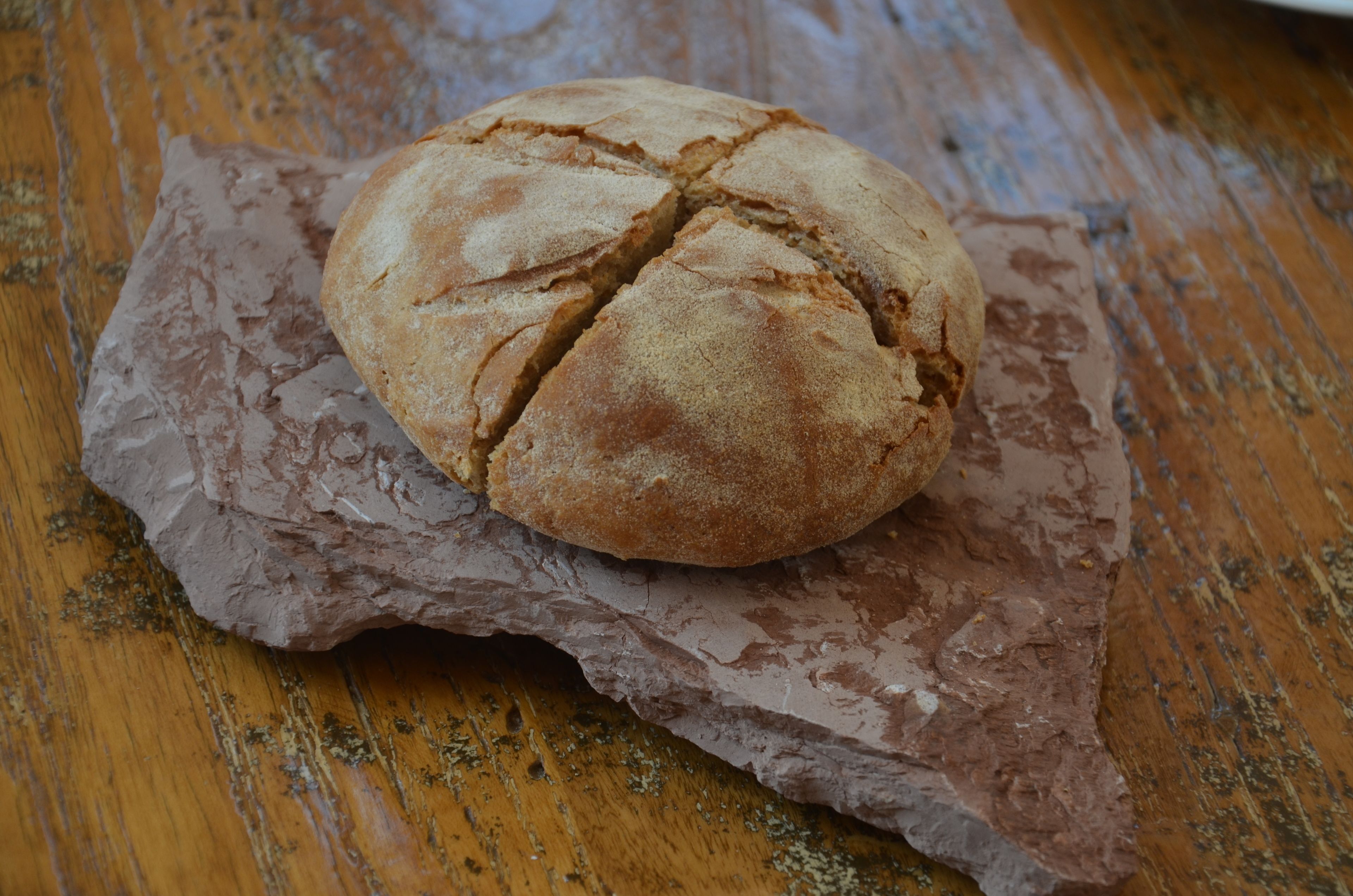 A loaf of bread on a wooden surface.