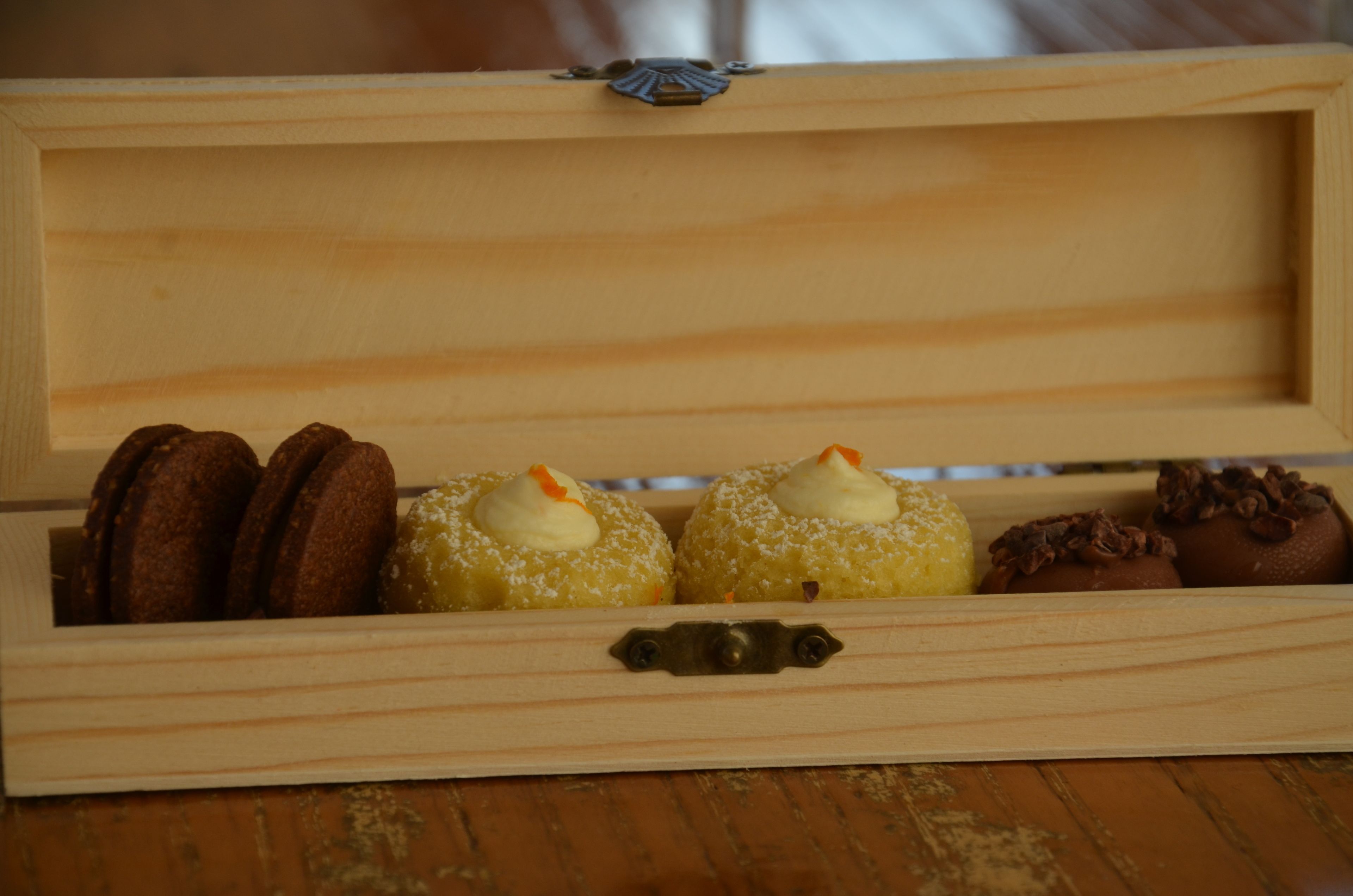 A wooden box containing various pastries.
