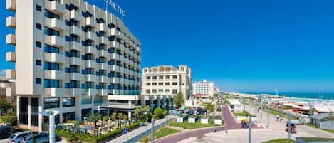 A modern hotel with a prominent 'BALTIC' sign, a central courtyard, and a view of the sea.