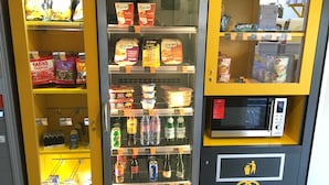 A vending machine with various food and drink options, including snacks, ice cream, and bottled beverages. - Première Classe Epinay Sur Orge Savigny Sur Orge (Epinay-sur-Orge)