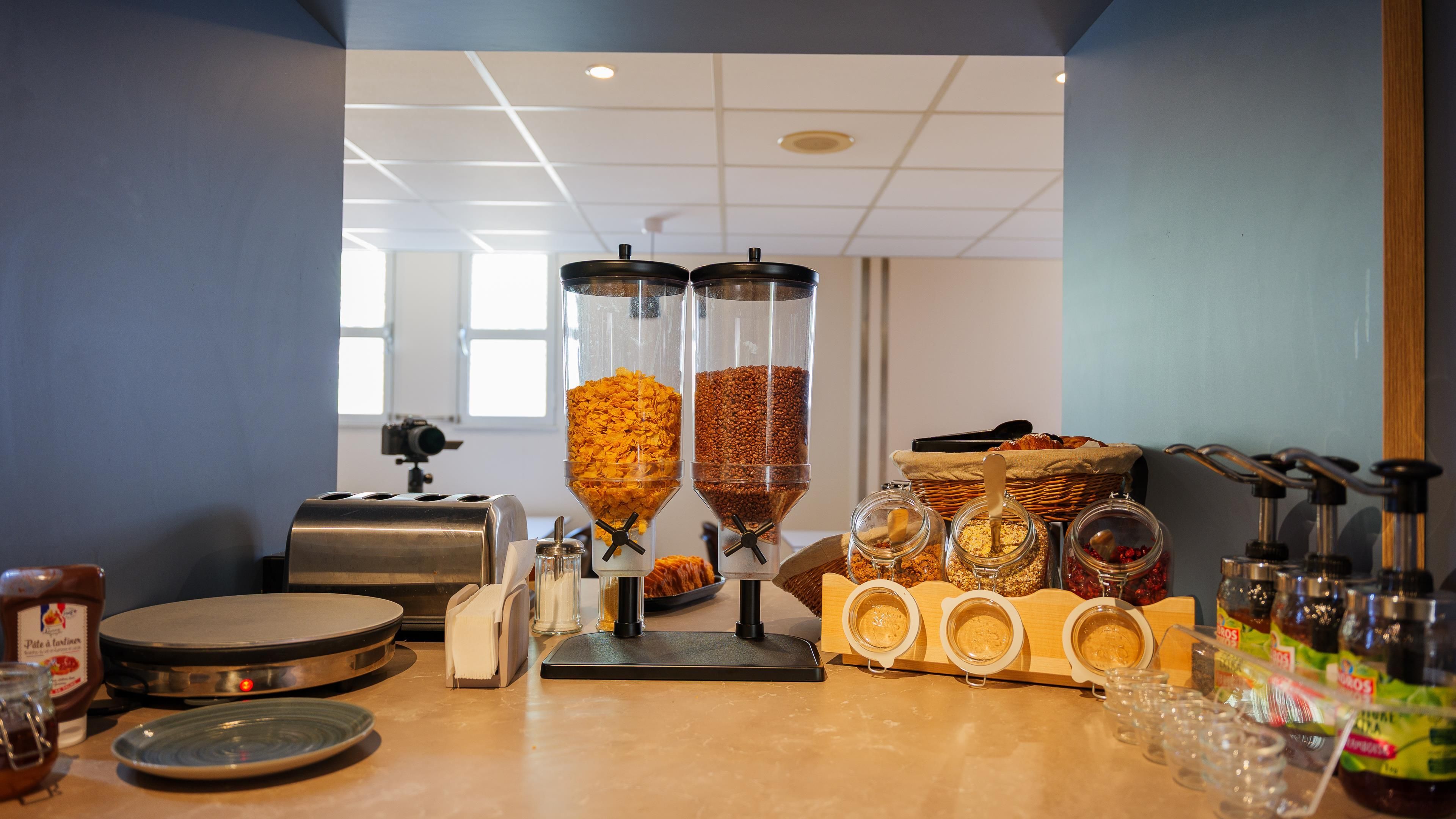 A breakfast bar with various food items and condiments.