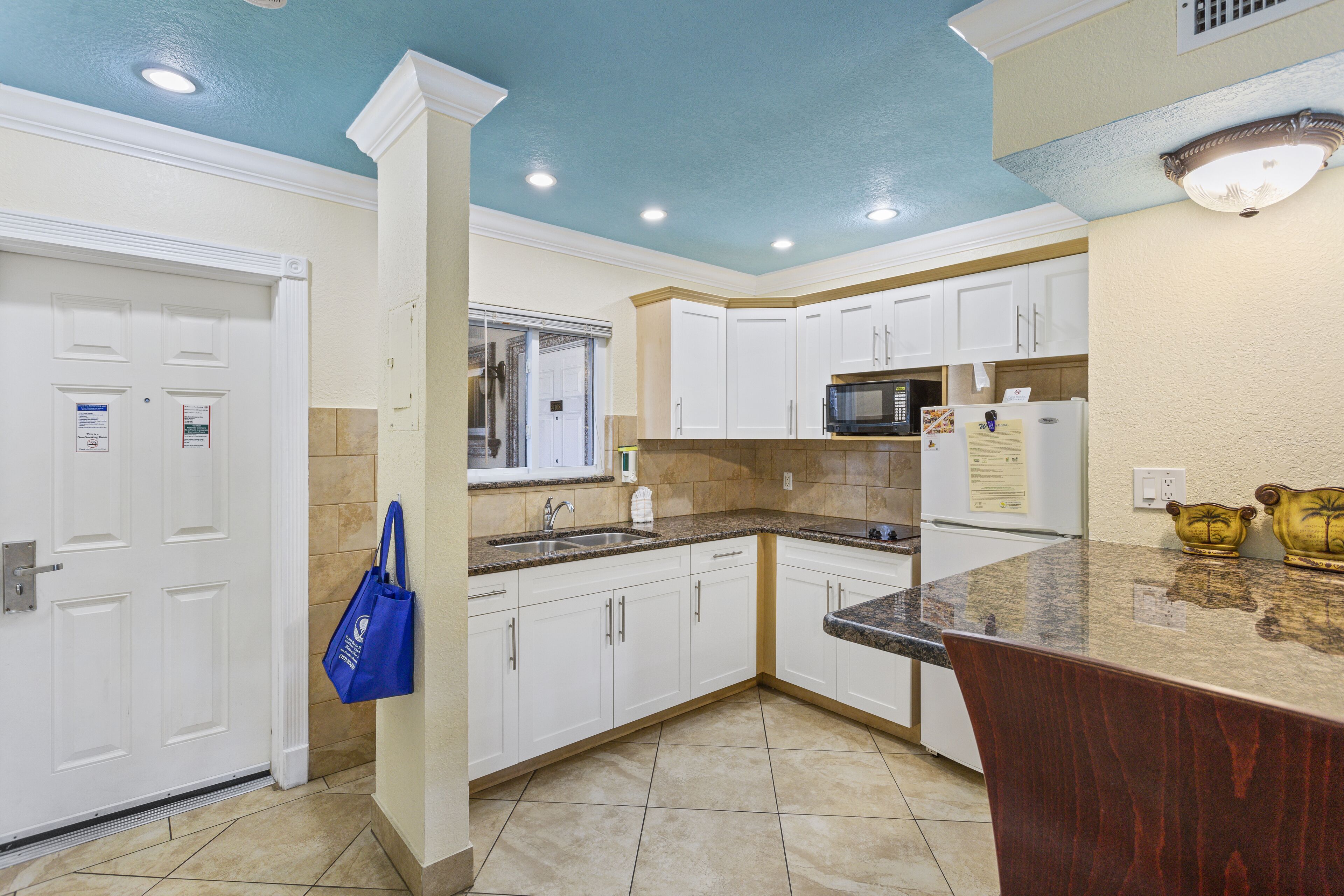 full-sized fridge, microwave, stovetop, coffee/tea maker