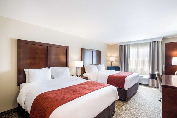 A hotel room with two beds, a desk, and a chair. - Comfort Inn Bonner Springs Kansas City (Bonner Springs)