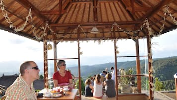 Enjoy meals al fresco with a view of the surrounding mountains.