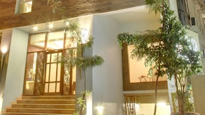 A multi-story building with a modern design, featuring a mix of wood paneling and glass windows. - juSTa OFF MG Road (Bengaluru)