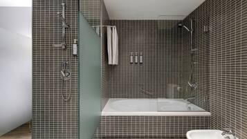 Un baño moderno con ducha de vidrio, bañera independiente y lavamanos blanco.