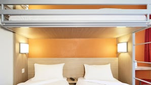 A bunk bed room with two beds, each with a red quilted bedspread and white pillows. There are two wall-mounted reading lights on either side of the beds. - Premiere Classe Charleville Mezieres (Charleville-Mezieres)