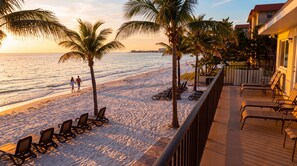 A beach with lounge chairs and a view of the ocean. - Hotel Sol (Redington Shores)