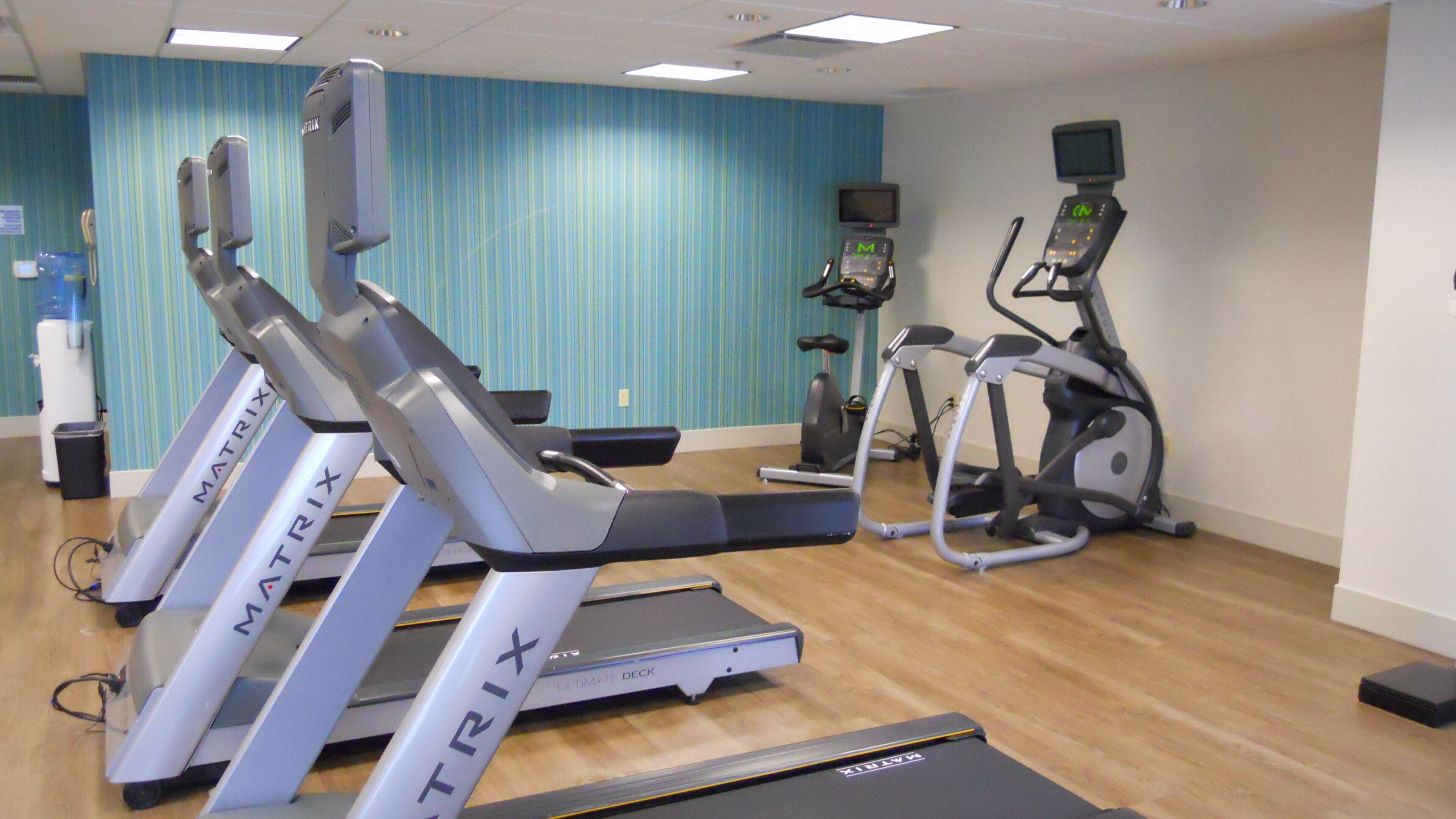 A gym with stationary bikes, treadmills, and exercise equipment.