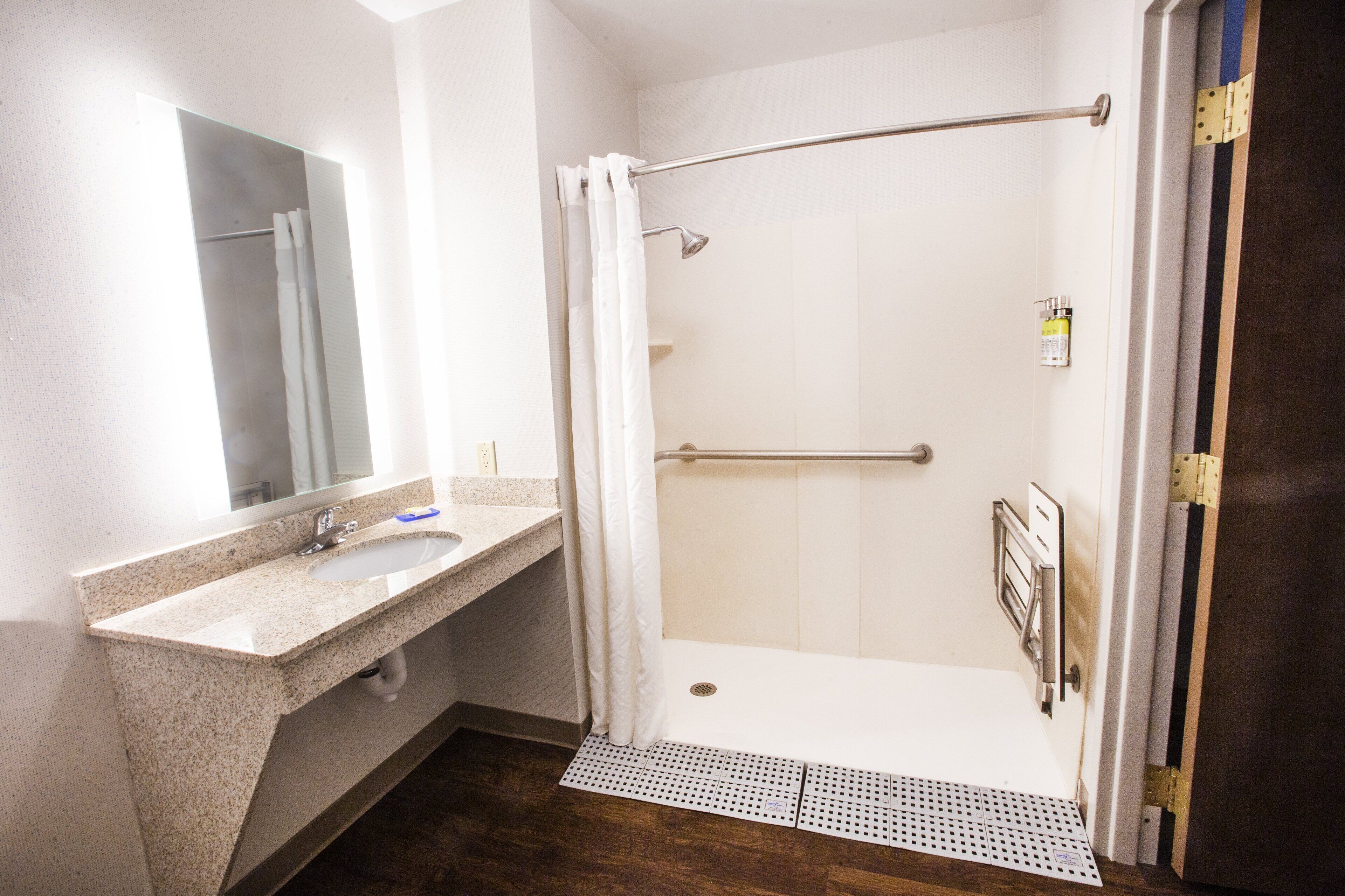 combined shower/bathtub, designer toiletries, hair dryer, towels