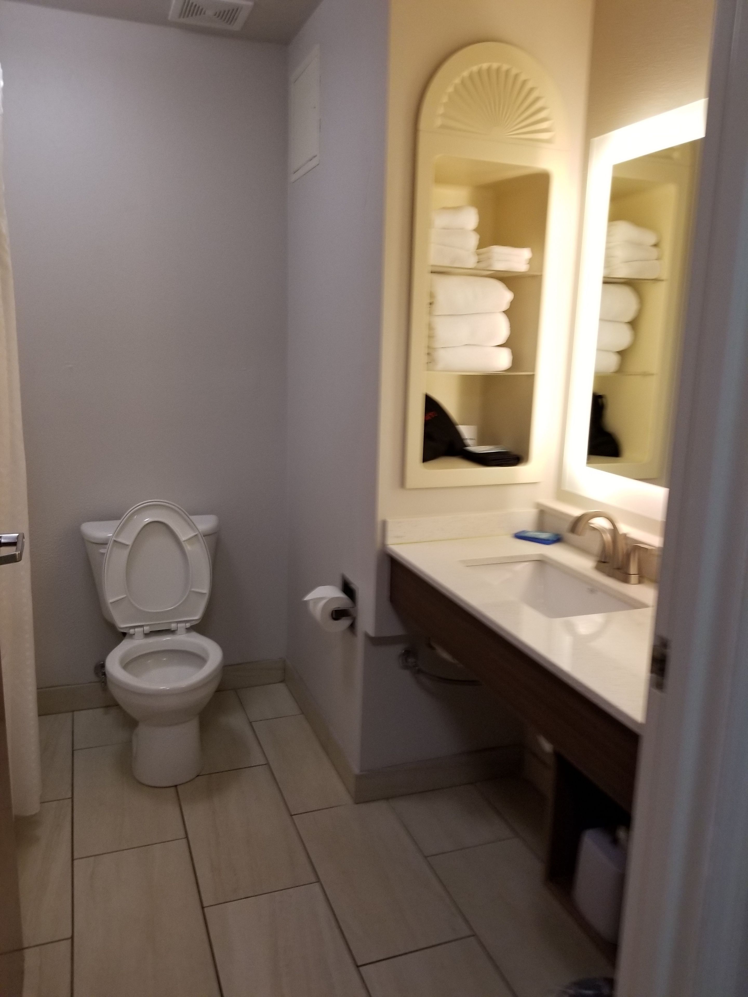 designer toiletries, hair dryer, towels