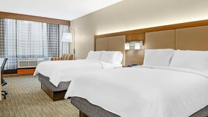 A hotel room with two beds, a large window with curtains, a desk with a chair, and a lamp. - Holiday Inn Express Hotel & Suites Hillview by IHG (Louisville)