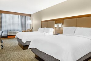 A hotel room with two beds, a large window with curtains, a desk with a chair, and a lamp. - Holiday Inn Express Hotel & Suites Hillview by IHG (Louisville)