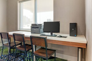 A hotel room with a desk, computer, printer, and two chairs. - Holiday Inn Express Hotel & Suites Hillview by IHG (Louisville)