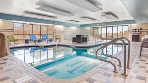 An indoor swimming pool with lounge chairs and a sun terrace. - Hampton Inn & Suites Greeley (Greeley)