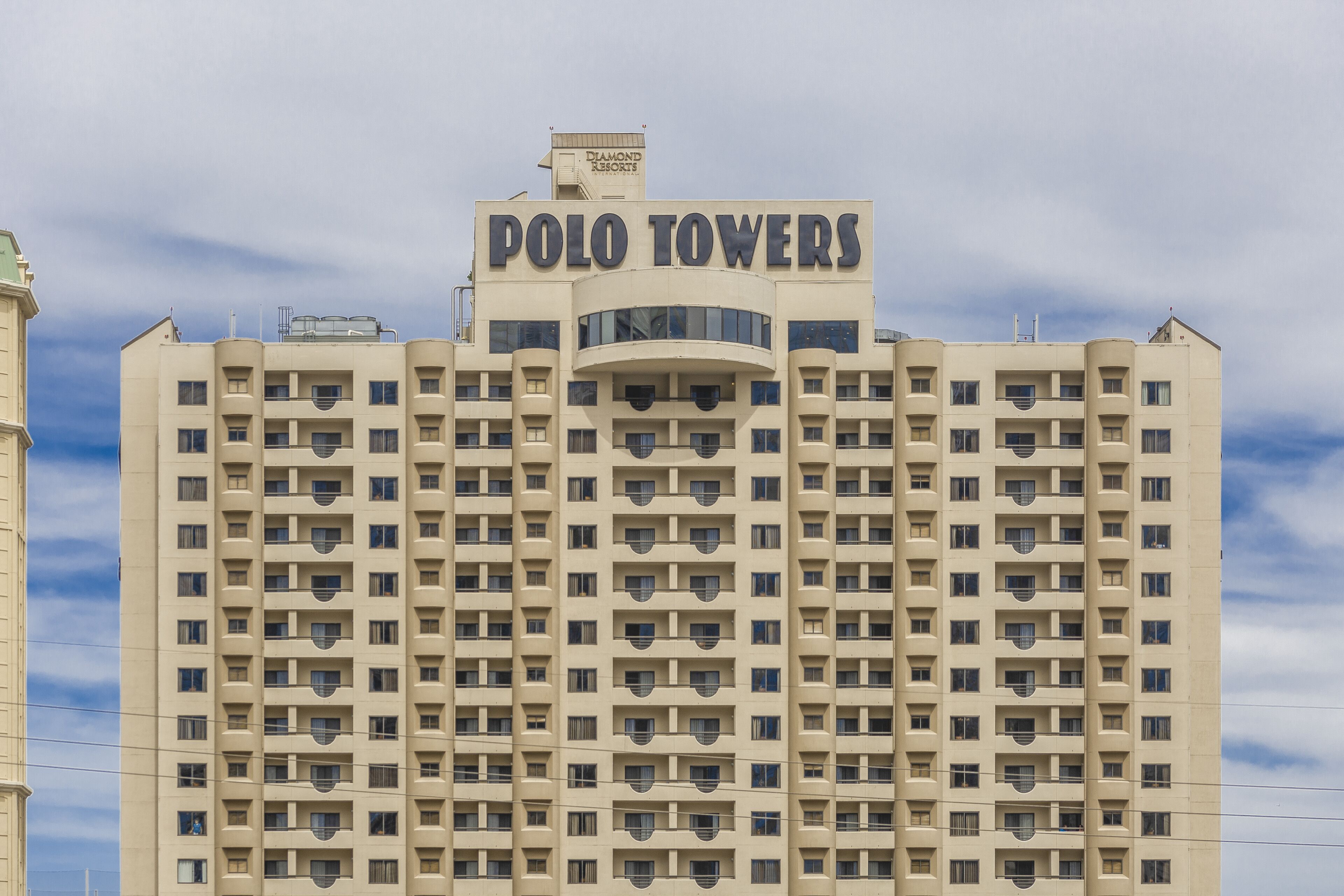 A high-rise building with the sign "POLO TOWERS" at the top.