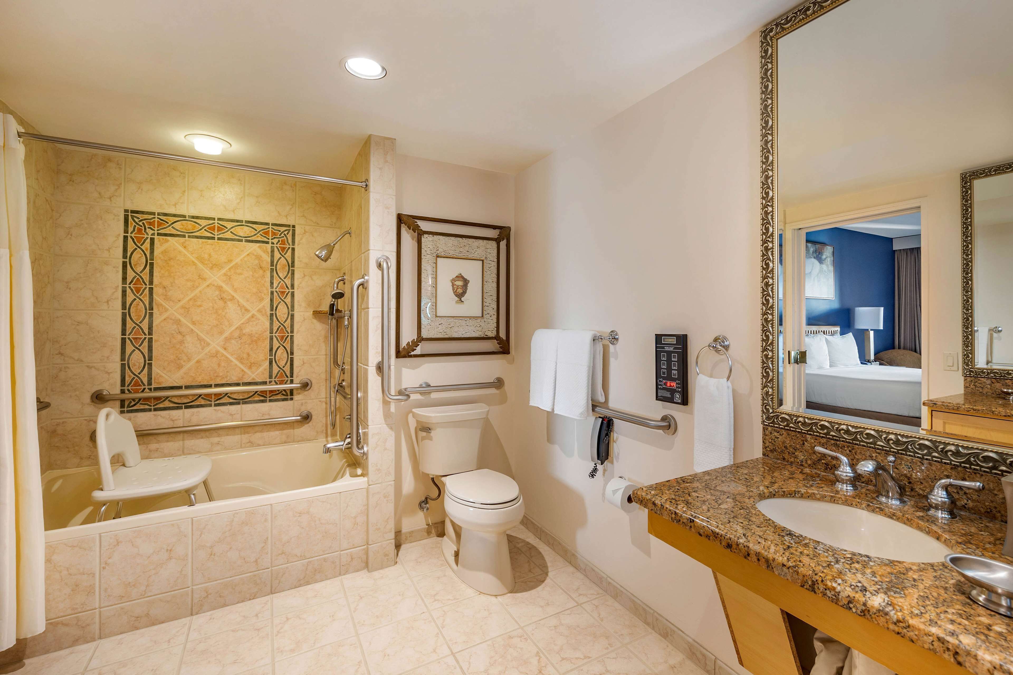 A modern bathroom with a bathtub, toilet, and sink.