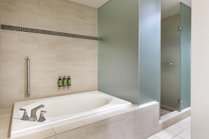 Suite, 1 King Bed | Bathroom | Combined shower/tub, designer toiletries, hair dryer, bathrobes