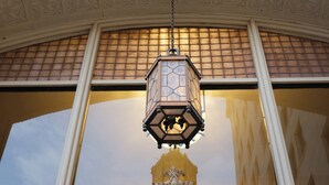 A detailed architectural ceiling with intricate carvings and a hanging lantern. - Colcord Hotel Oklahoma City, Curio Collection by Hilton (Oklahoma City)