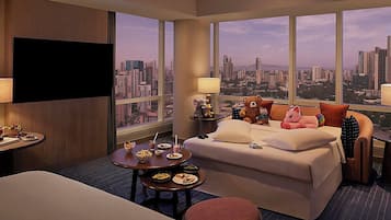 Enjoy a city view from the sofa bed and dining table in this stylish room.